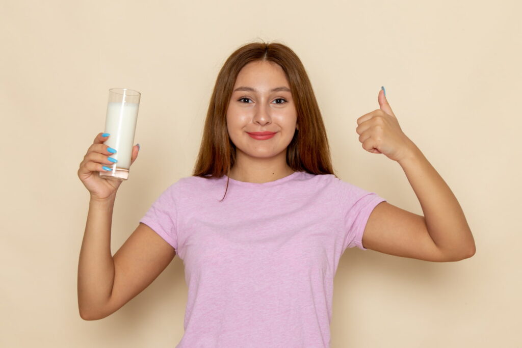 Young attractive girl drinking Milk with Lactose Sensitivity